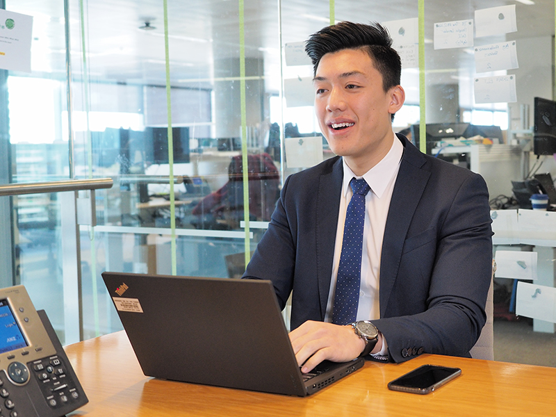 ANZ Graduate on his computer
