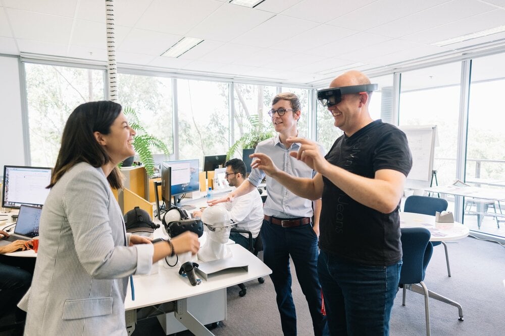 3 professionals on a meeting, testing virtual reality headsets