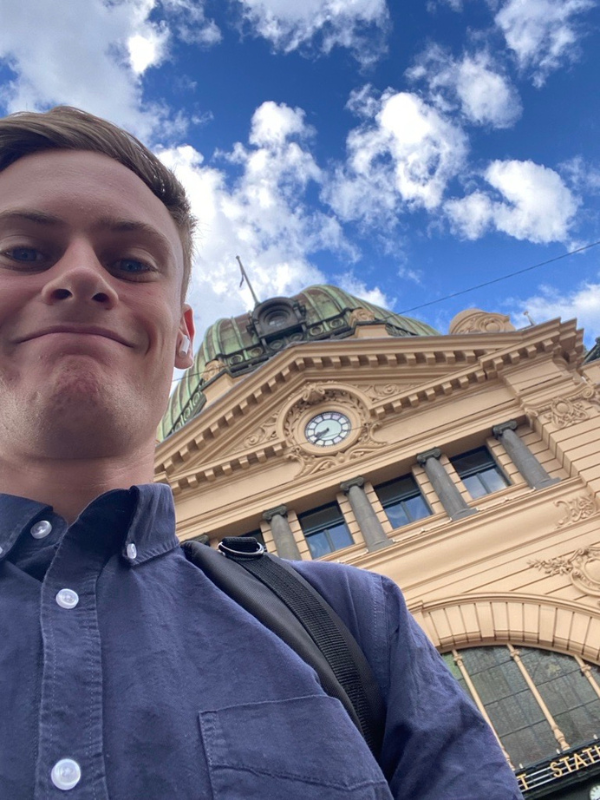 Escient Graduate-Jack standing outside the train station