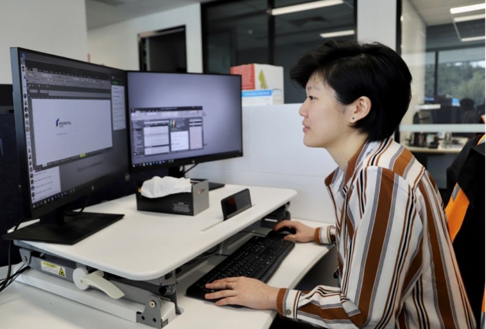 Rheinmetall Defence -Cindy Lim working on her desk