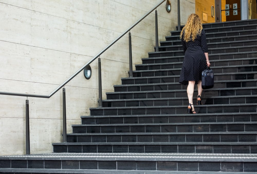 WSP Graduate- A young female professional climbing the stairs to the office.