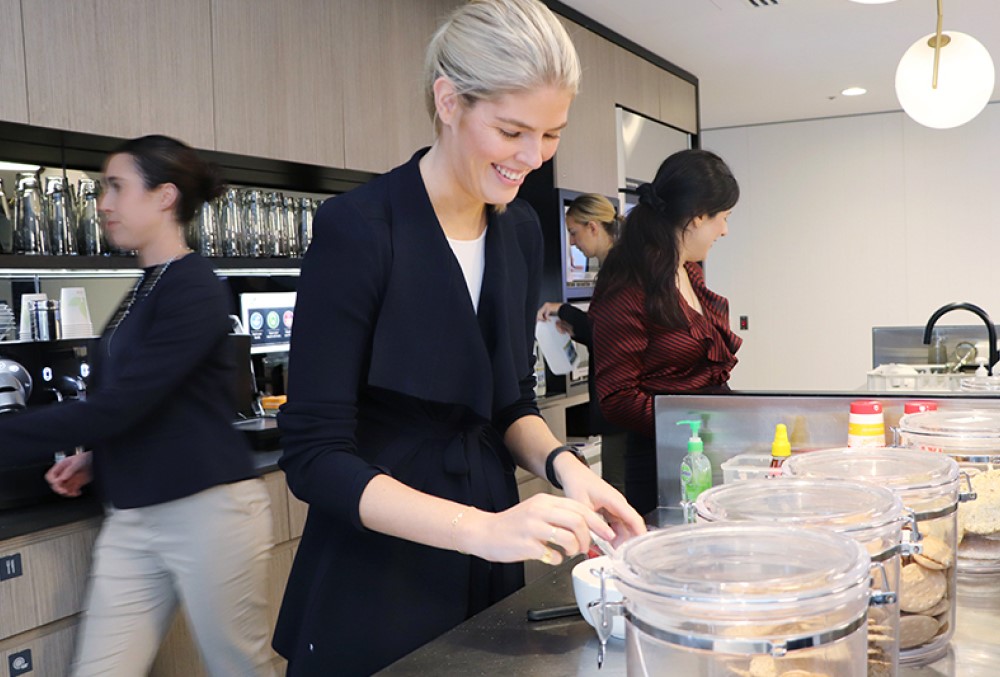 Sparke Helmore Lawyers Graduate - Young female lawyer serving food on plate.