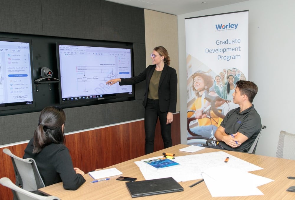 Worley Graduate - Young female professional meeting with her team.