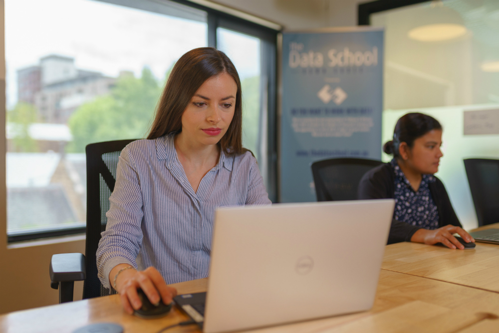 The Data School Jasna Dishlieska Mitova on her desk with a laptop