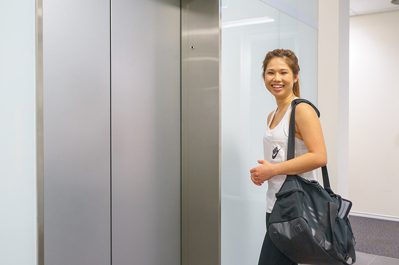 Catherine Lo in front of an elevator