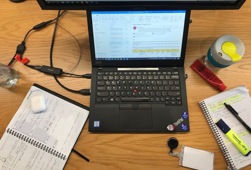 Capgemini Australia Graduate - Desk with laptop, notebooks, pen, and highlighter