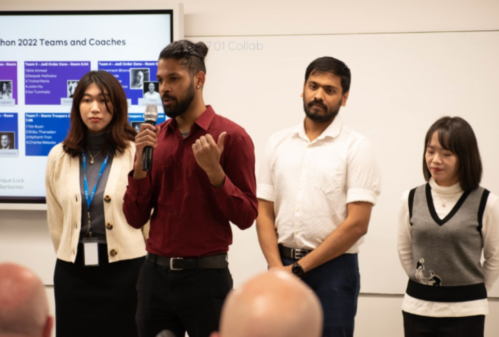 Cenitex Graduate - Young professional speaking at the Cenitex Hackathon.