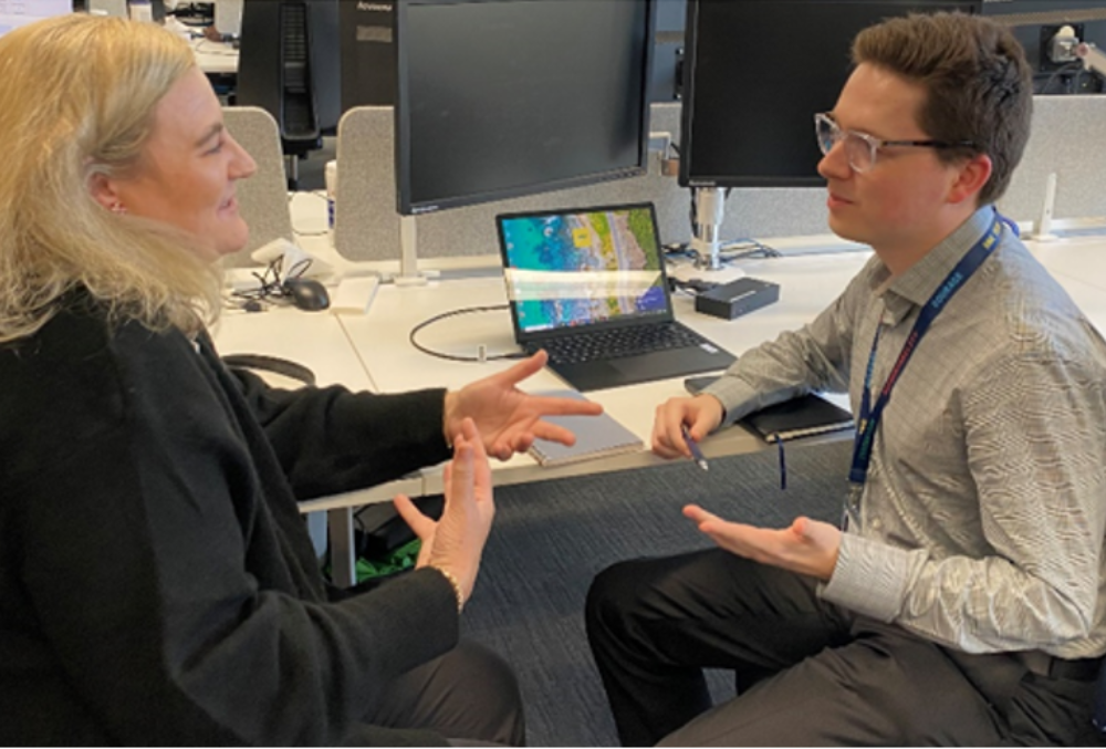 day in the life Thomas Uwins RACV talking with a colleague after presentation