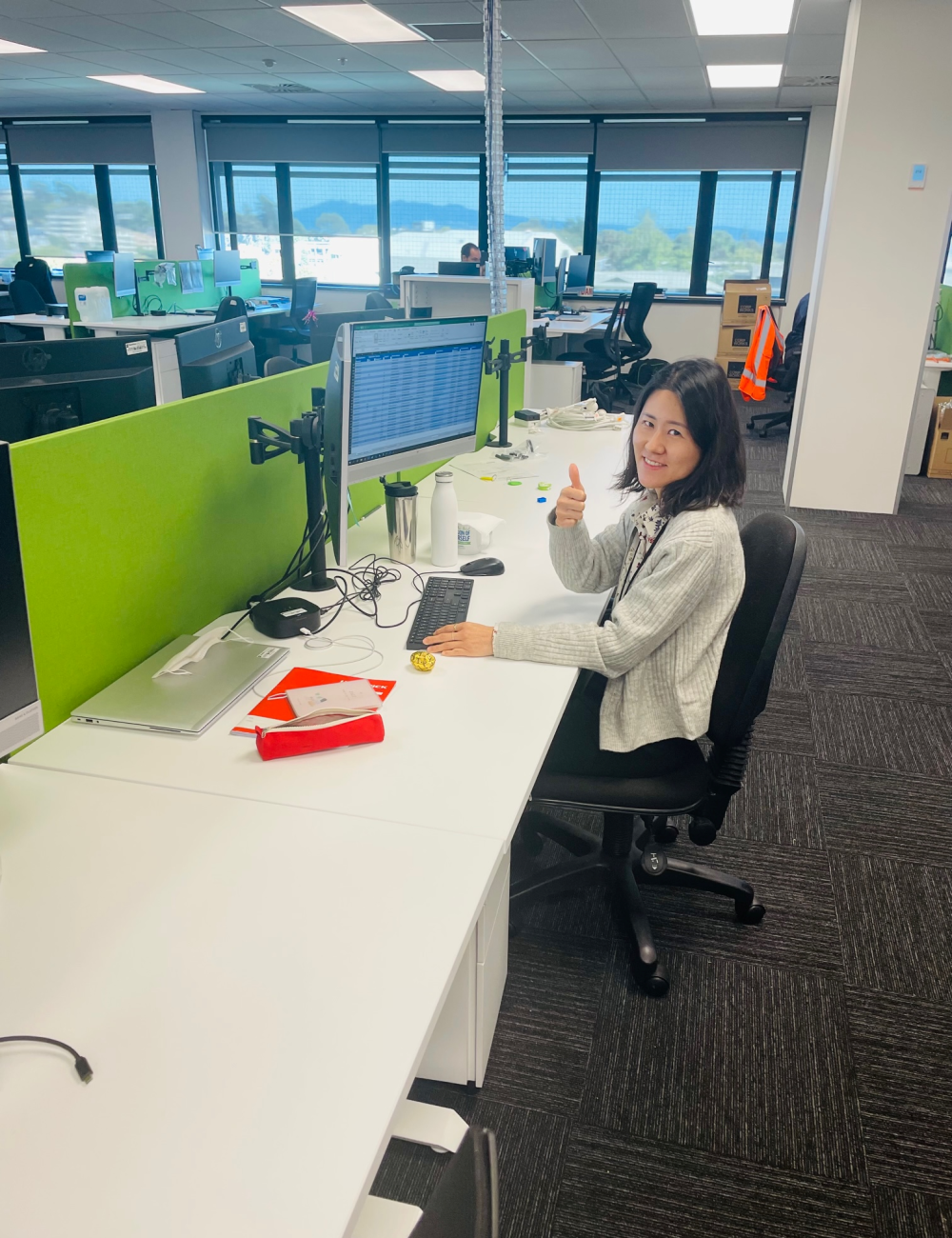 Hamilton City Council Graduate - Young professional sitting on her desk.