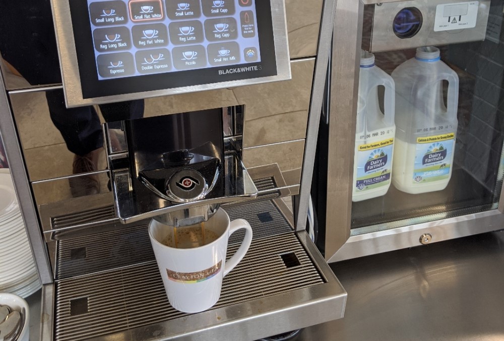 Clayton Utz - Coffee cup on a coffee maker machine