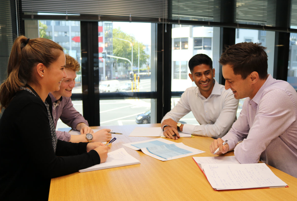 Beca Graduate- A team of young professional having a business meeting.