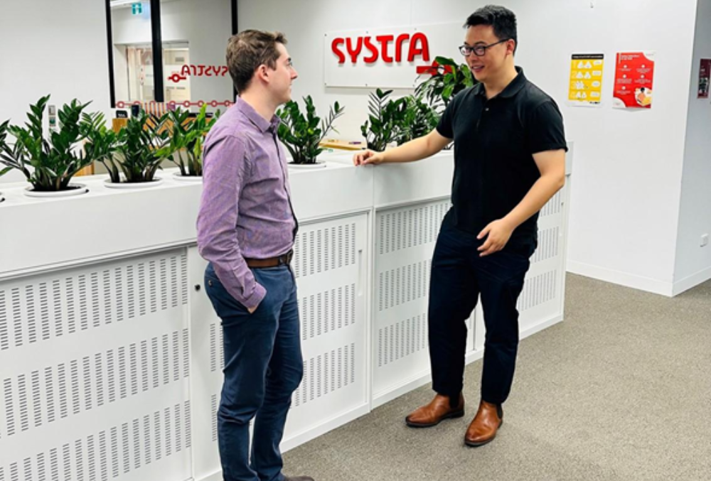 day in the life Benjamin Voss SYSTRA ANZ catching up with a colleague