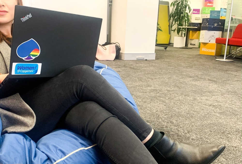 Capgemini Australia Graduate - Young female professional with a laptop sitting on a beanbag lounge.