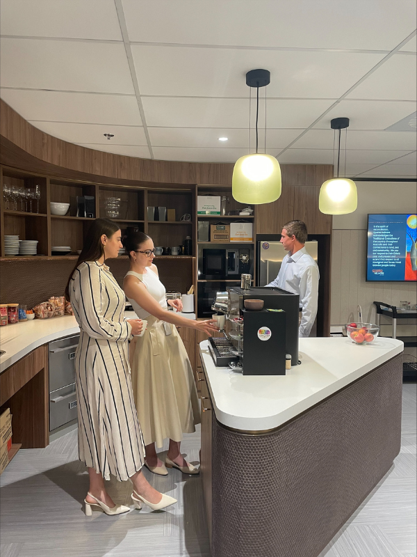 people in the staff kitchen making coffee