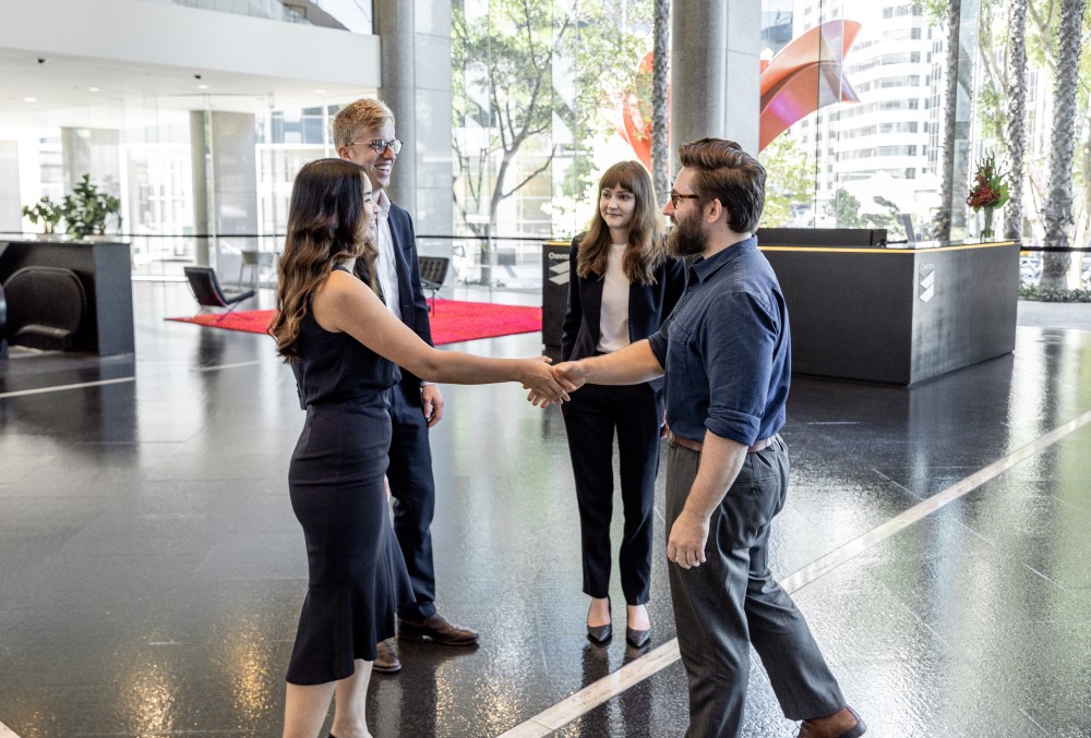 Herbert Smith Freehills Graduate - Young female professional shaking hands with the client.