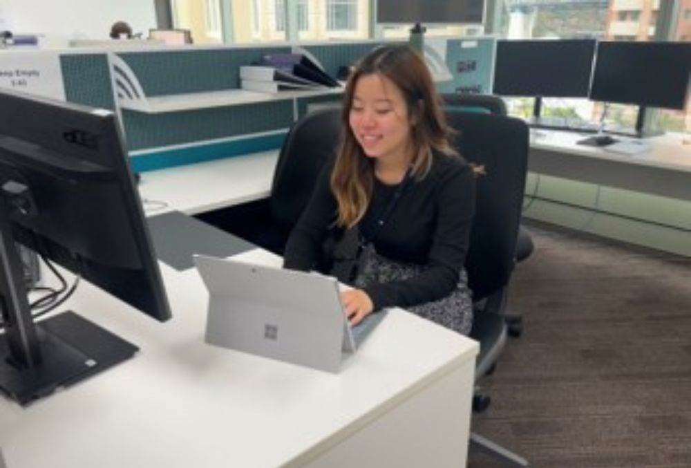 APRA Rachel Tan working on her desk