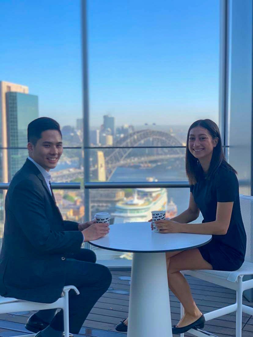 Two young professionals at their office building skydeck