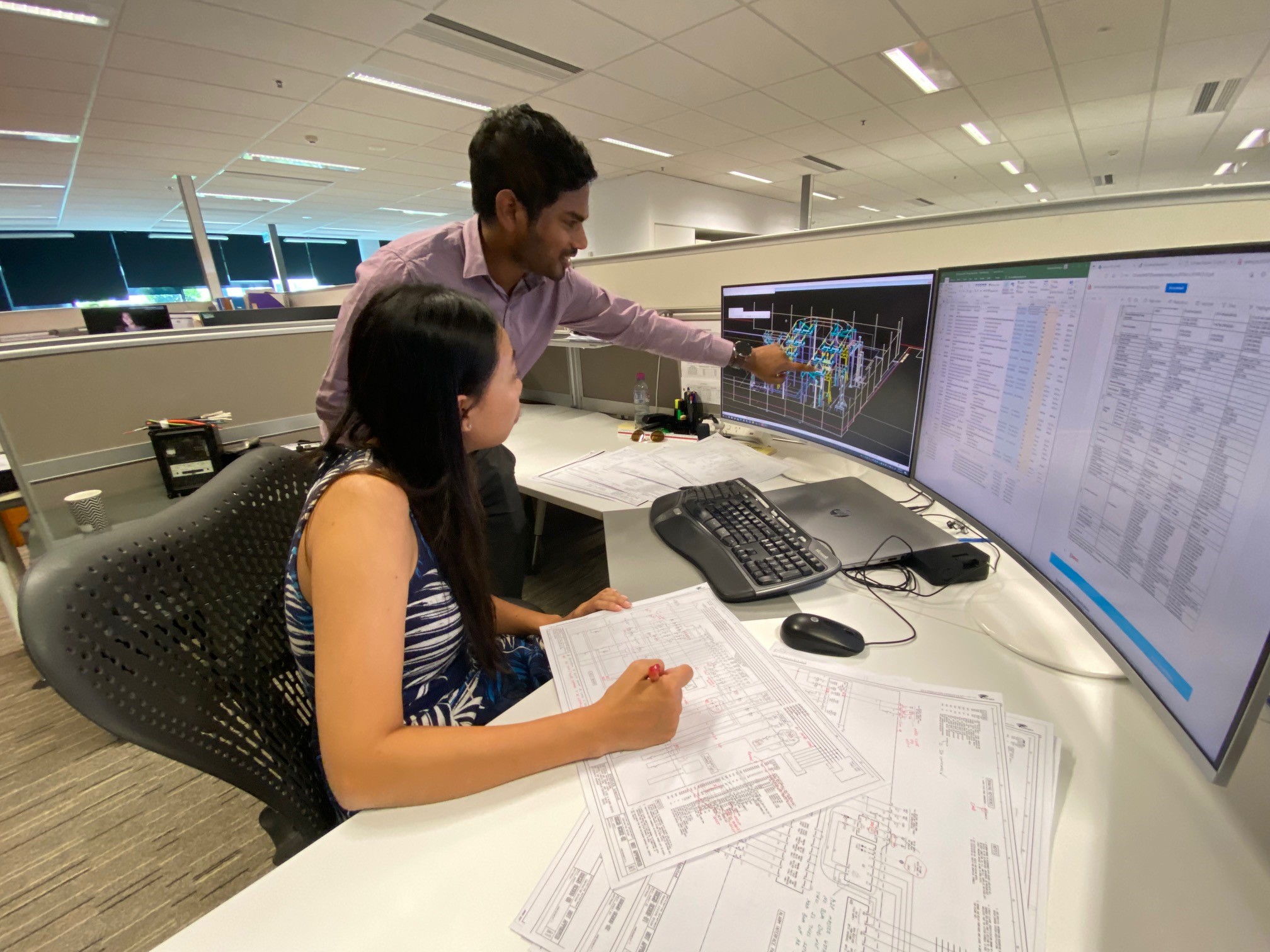 amy checking on circuit designs on a monitor