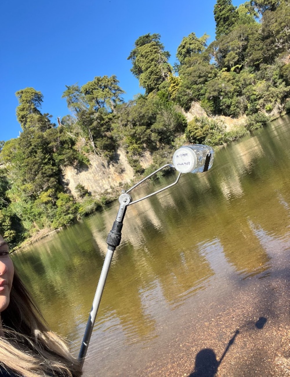 Hamilton City Council Graduate - Young professional taking water sample from the river.