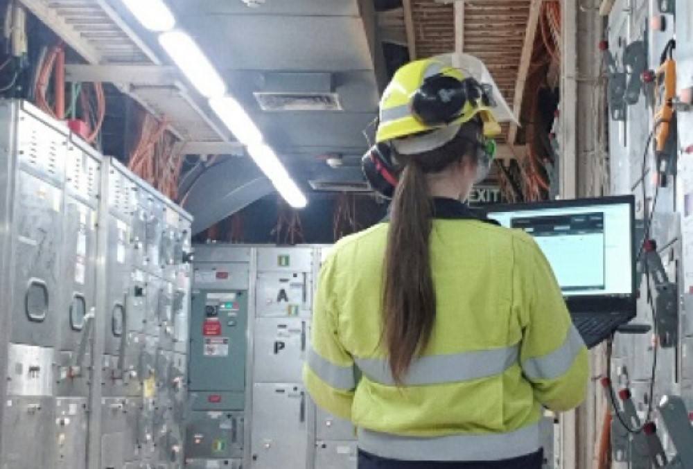 Alcoa of Australia Graduate - Young female professional on-site wearing personal protective equipment.